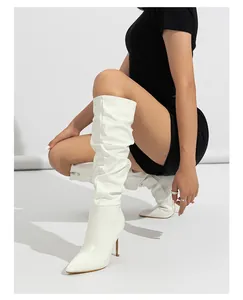 Elegant white patent leather slouchy knee-high boots with sexy thin high heels