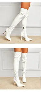 Detailed view of sexy white over-the-knee high heel boots with pointed toe