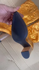 Detailed view of non-slip sole and block heel of metallic orange cowboy boots