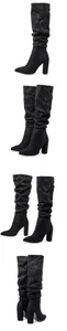 Elegant black slouchy high-heeled boots featuring a pointed toe and chunky block heel