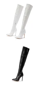 Detail view of white and black crocodile embossed over-the-knee stiletto boots