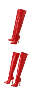 Macro detail view showing the red crocodile-embossed texture on stiletto thigh-high boots.