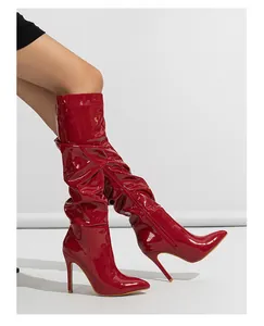 Red patent leather high heel boots with pleated slouchy design and side zipper detail.