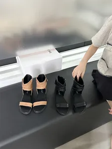 Stylish flat gladiator sandals in black and tan with ankle straps for summer wear