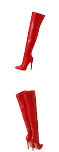 Detailed view of red crocodile-patterned thigh-high boots with stiletto heels