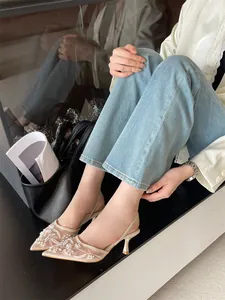 Elegant white embroidered mesh slingback heels shown on model with casual jeans