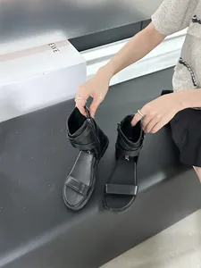 Close-up of black flat Roman sandals with ankle strap zipper and comfortable soft sole