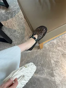 Close-up of stylish black woven Mary Jane flats featuring a breathable mesh design