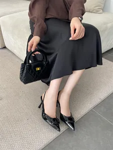 Elegant black patent leather slingback pumps with pointed toe and square buckle detail