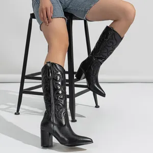 Elegant black western cowboy boots featuring intricate embroidered patterns and chunky high heels