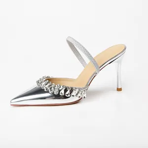 Silver metallic pointed toe high heel sandals with rhinestone fringe and thin strap.