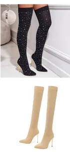 Close-up detail of luxury rhinestone over-the-knee boots with pointed toe and thin stiletto heels