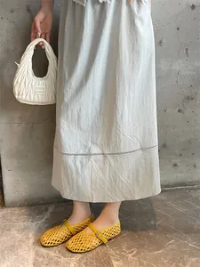 Detail view of yellow handmade woven Mary Jane flats with an adjustable buckle strap