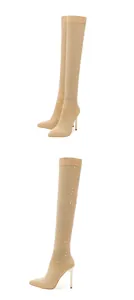Nude rhinestone embellished thigh-high boots with pointed toe and stiletto heels