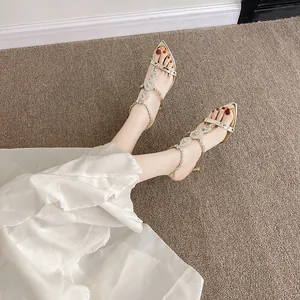 Elegant gold pointed-toe high heel sandals featuring sparkling rhinestone embellishments