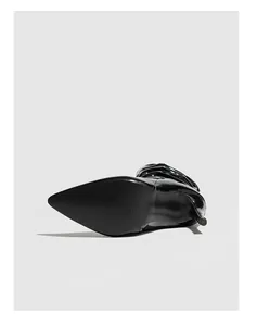 Bottom view of black patent leather stiletto boots with pleated design details