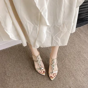 Elegant gold pointed-toe high-heel sandals with luxury rhinestone detailing for women.