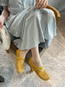 Stylish yellow hand-woven Mary Jane flats shown on model with a light blue dress