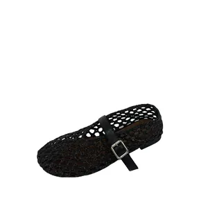 Close-up detail of black woven texture and silver buckle on Mary Jane summer flats