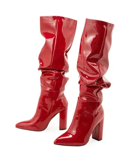 Glossy red patent leather slouchy mid-calf boots with pointed toe and block heel