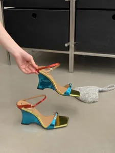 Close-up of metallic gradient wedge sandals with unique concave heel and color-blocking