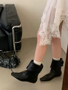 Stylish black leather fold-over Chelsea boots with a pointed toe for a modern daily look.