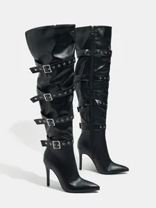 Detail of black over-the-knee boots with multiple buckle straps and stiletto heels