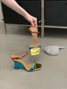 Detailed view of tri-color metallic wedge sandals with irregular heel and silver bag