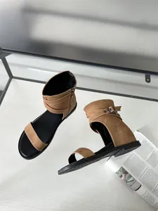 Close-up detail of stylish brown high-top Roman sandals with buckle and soft flat sole