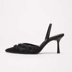 Elegant black lace slingback high heels with pointed toe and slender stiletto heel.