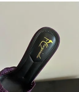 Detailed close-up of breathable black leather insole on purple lace stiletto mule sandals