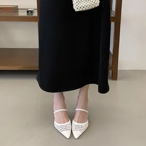 Elegant white woven pointed-toe high-heel sandals shown in a professional studio setting
