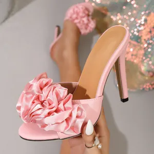 Elegant pink satin mule featuring a large 3D fabric flower detail and stiletto heel.