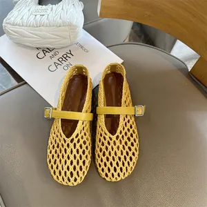 Detailed view of yellow woven Mary Jane flats featuring a hollow-out design and buckle strap
