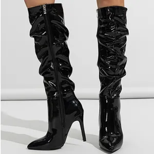 Sexy black patent leather slouchy knee-high boots with stiletto heel and pointed toe