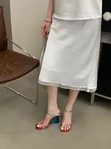 Elegant metallic gradient wedge sandals with square toe worn by model in skirt