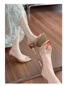 Detail view of champagne lace pointed-toe stiletto mules with transparent strap
