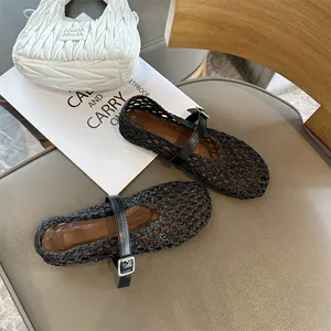 Detailed shot of breathable black woven Mary Jane flats with single strap buckle design