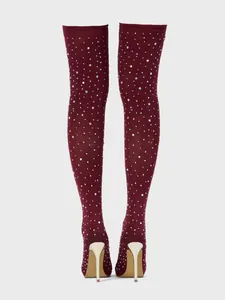 Detail view of burgundy rhinestone over-the-knee boots with elegant gold stiletto heels