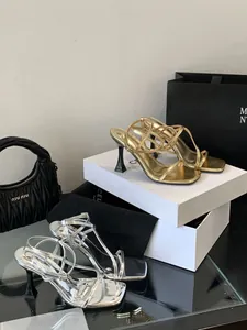 Elegant metallic strappy high-heeled sandals in gold and silver finishes