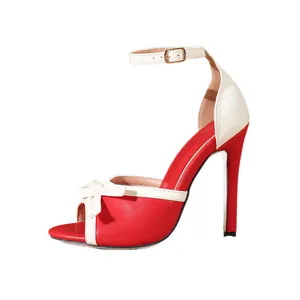 Elegant red and white color-block stiletto sandals with bow detail and ankle strap.