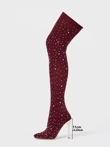 Side view of wine red rhinestone over-the-knee boots with 11cm stiletto heel height measurement.