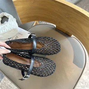 Close-up detail of black handmade woven Mary Jane flats with breathable hollow mesh design