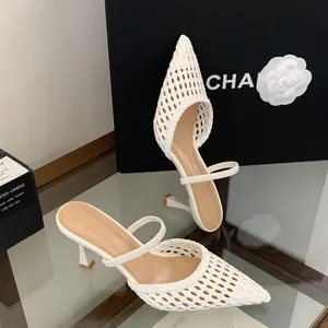 Detailed view of the intricate white woven texture on pointed toe stiletto mules