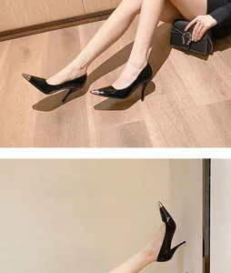 Detailed view of elegant black stiletto pumps with silver-tone metal pointed toe caps.