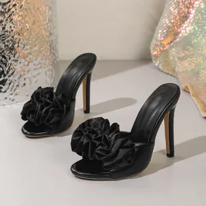 Sexy black high heel sandals featuring elegant ruffled flower decor and stiletto heels
