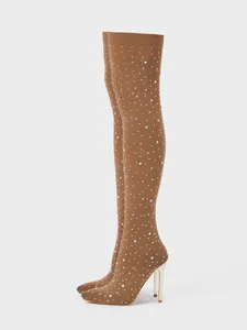 Detailed view of rhinestone-embellished over-the-knee boots with stiletto heels.
