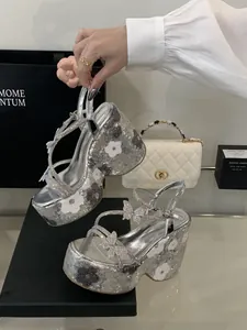 Close-up of silver sequined platform wedge sandals featuring sparkling butterfly charms