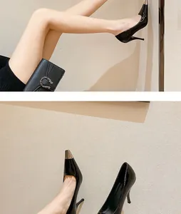 Close-up of black pointed-toe stiletto pumps with metallic gold cap toe detail