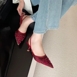 Elegant burgundy pointed-toe heels with intricate floral embroidery and mesh slingback strap